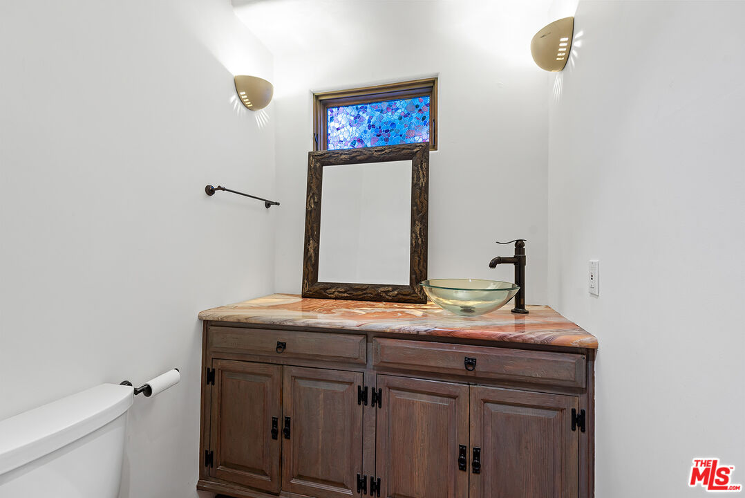 7047 Vista Del Mar Lane Playa del Rey, CA 90293 - Photo 22 of 75 a bathroom with a granite countertop sink a toilet and a mirror