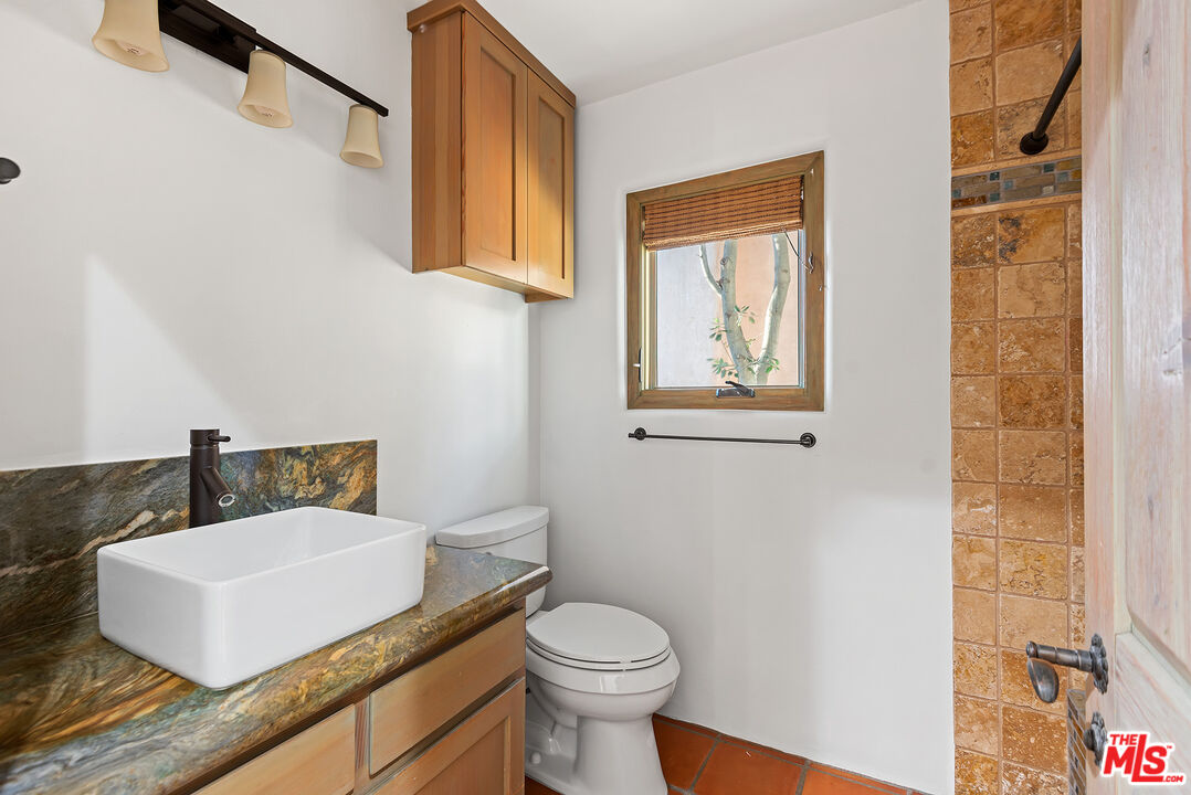 7047 Vista Del Mar Lane Playa del Rey, CA 90293 - Photo 43 of 75 a bathroom with a granite countertop sink mirror vanity and toilet