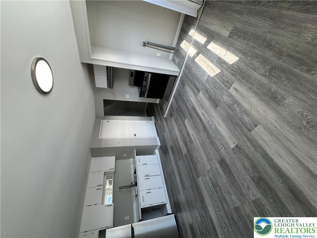 702 Walnut Street, Unit 2 Freeland, PA 18224 - Photo 5 of 8 Step into a sun-filled kitchen featuring sophisticated wood-look flooring.