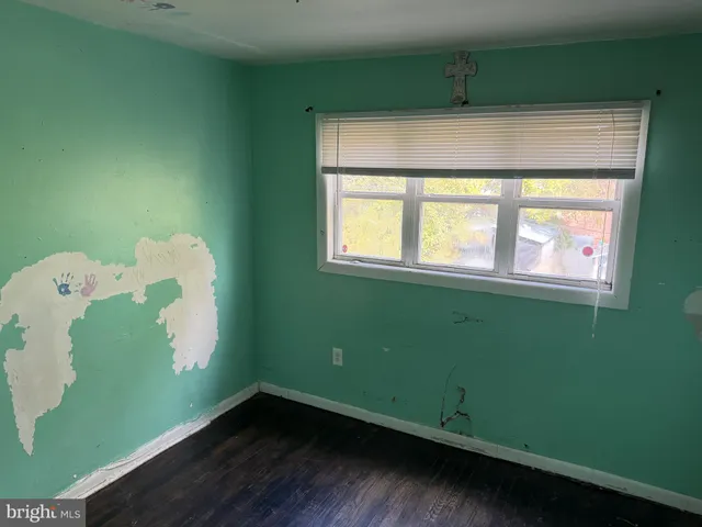 a room with a window and a wooden floor