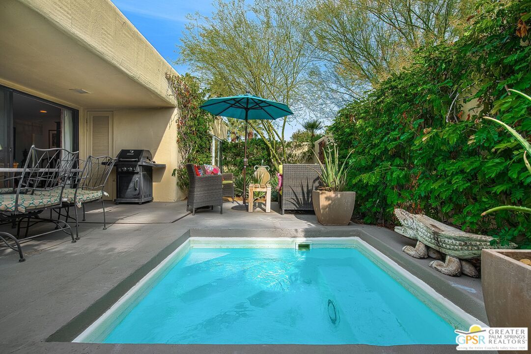1177 East Alejo Road Palm Springs, CA 92262 - Photo 1 of 33 a view of a chairs and table in backyard