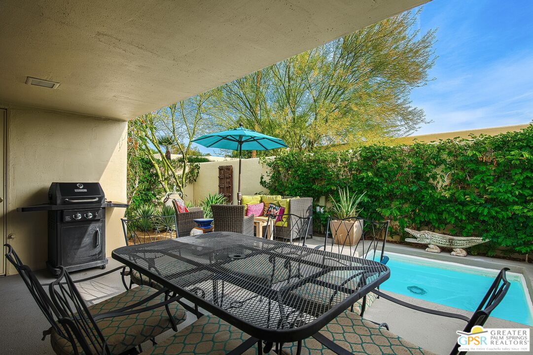 1177 East Alejo Road Palm Springs, CA 92262 - Photo 14 of 33 a view of a backyard with furniture and a garden
