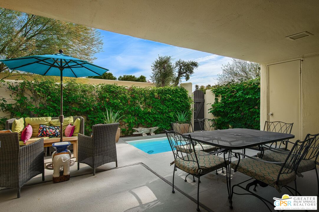 1177 East Alejo Road Palm Springs, CA 92262 - Photo 15 of 33 a view of backyard with seating space and trees