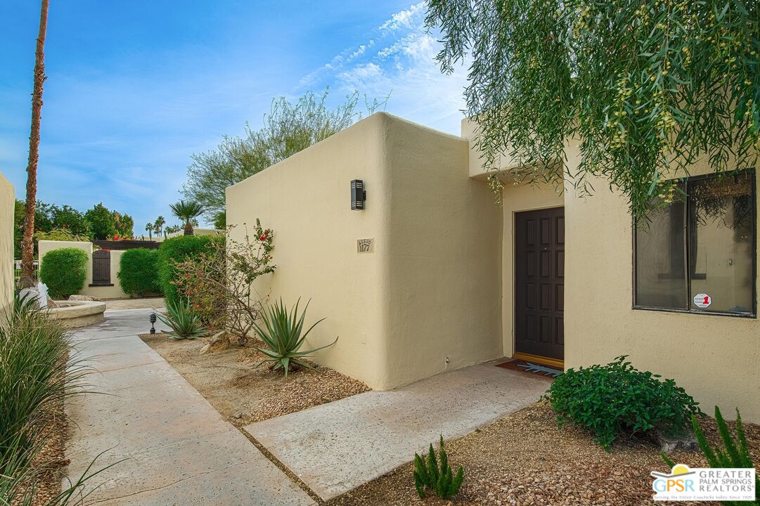 1177 East Alejo Road Palm Springs, CA 92262 - Photo 3 of 33 a view of a house with a yard and potted plants