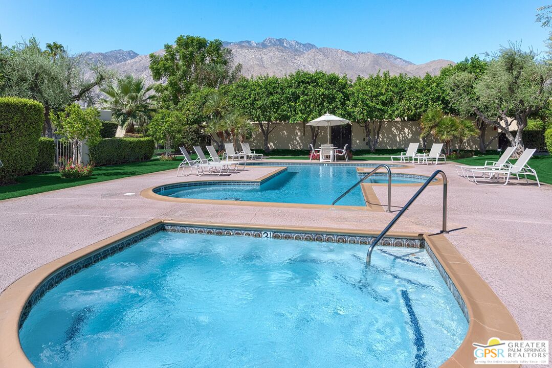 1177 East Alejo Road Palm Springs, CA 92262 - Photo 31 of 33 a view of a swimming pool with a yard