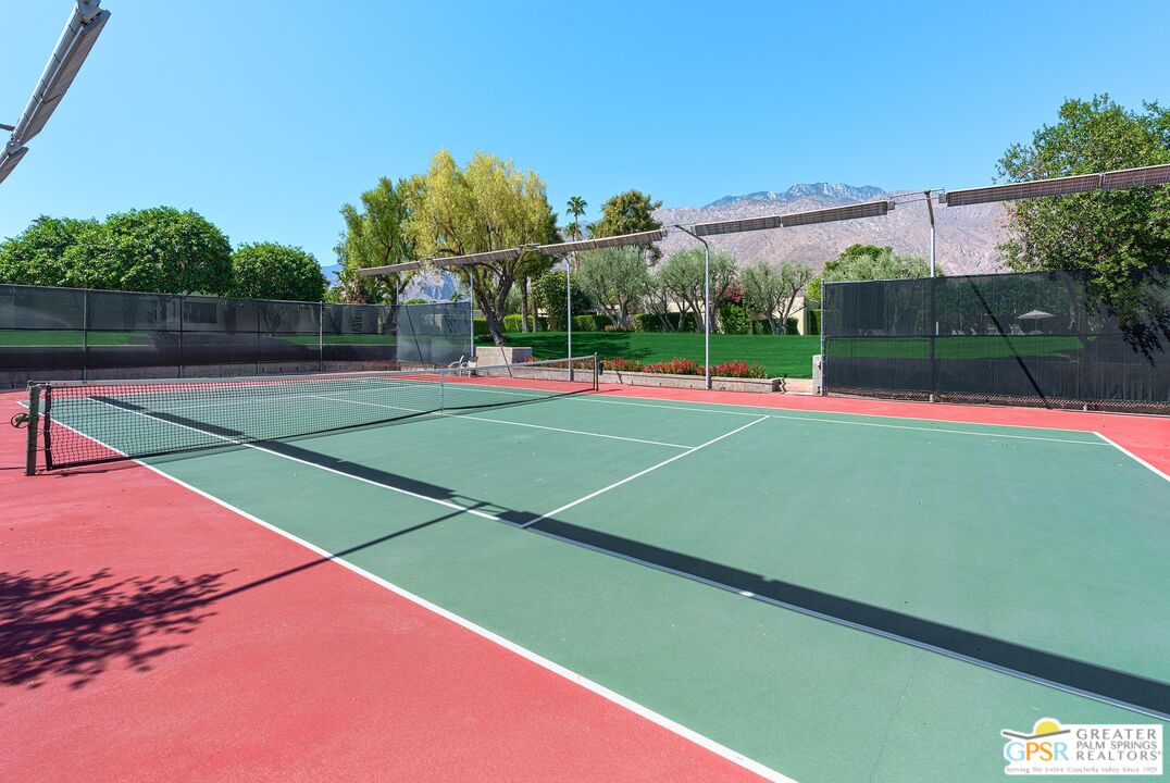 1177 East Alejo Road Palm Springs, CA 92262 - Photo 32 of 33 a view of an outdoor space and tennis court