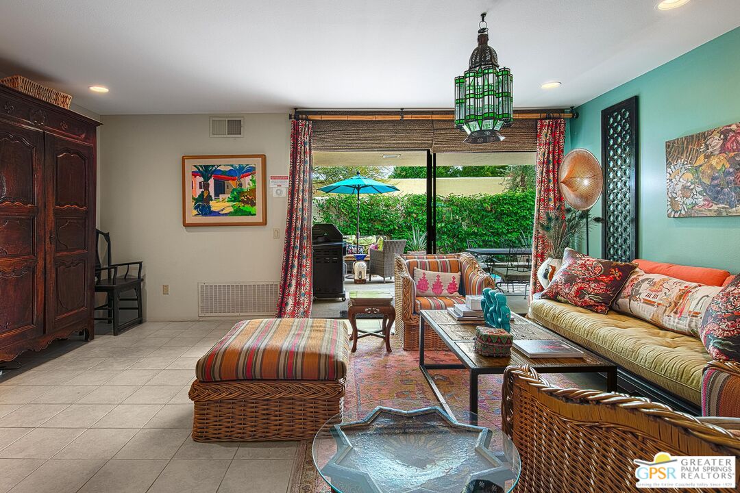 1177 East Alejo Road Palm Springs, CA 92262 - Photo 8 of 33 a living room with furniture a window and a flat screen tv