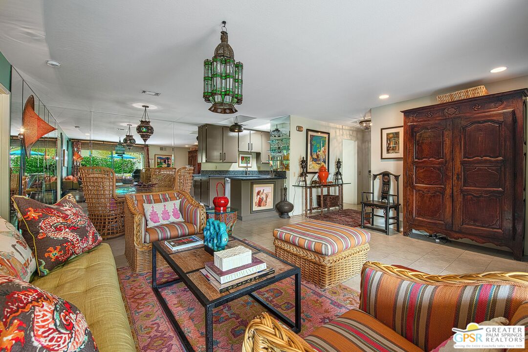 1177 East Alejo Road Palm Springs, CA 92262 - Photo 9 of 33 a living room that has couches and a dining table with garden view