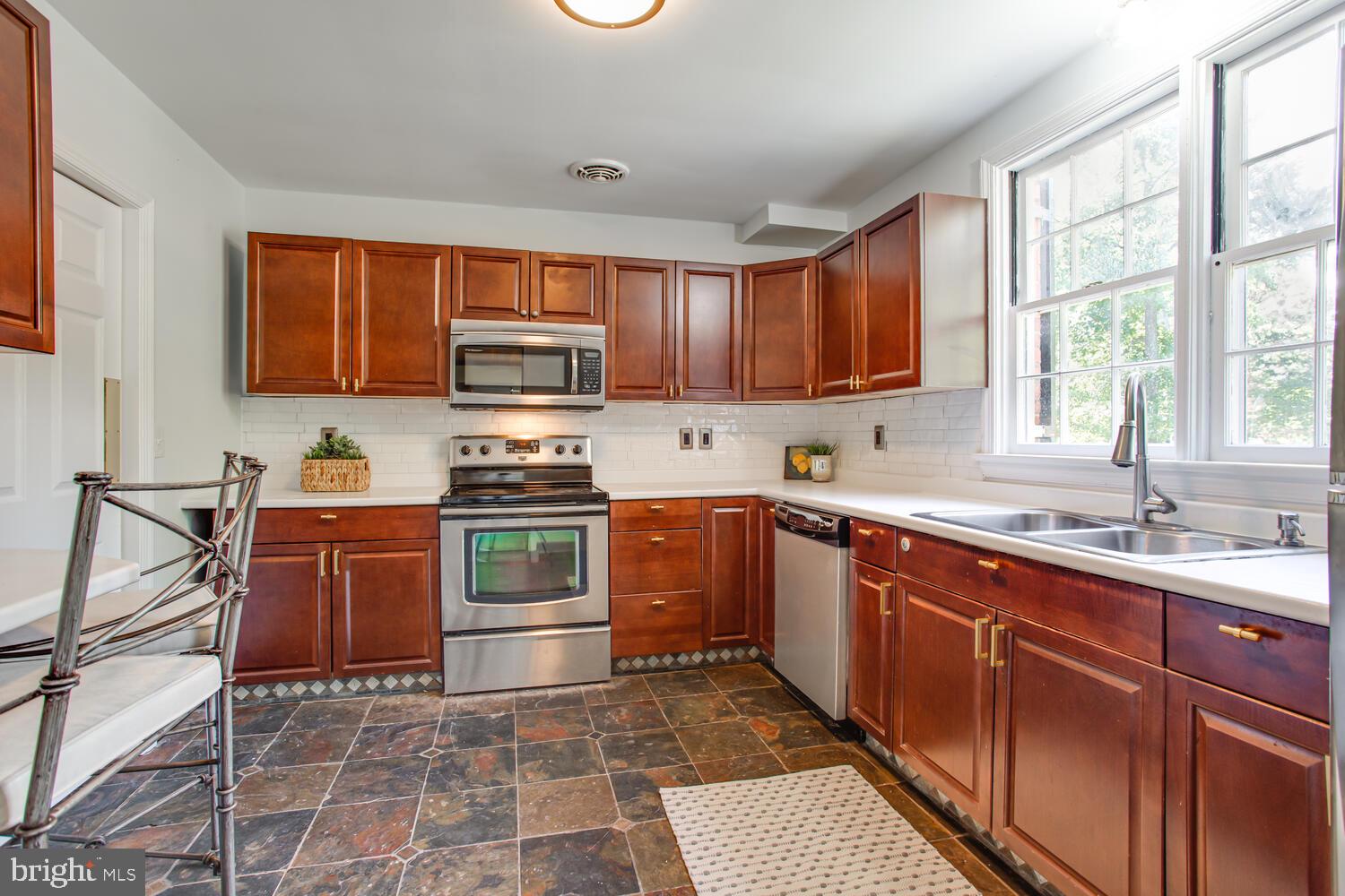 6921 Fort Hunt Road Alexandria, VA 22307 - Photo 13 of 41 Kitchen with wood cabinets and tile floor