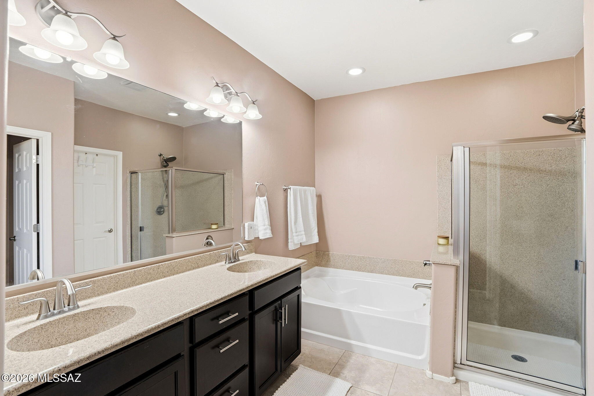 211 East Refuge Loop Vail, AZ 85641 - Photo 18 of 48 a bathroom with a bathtub a sink and a mirror