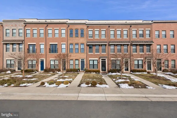 a front view of a building with lot of cars on it