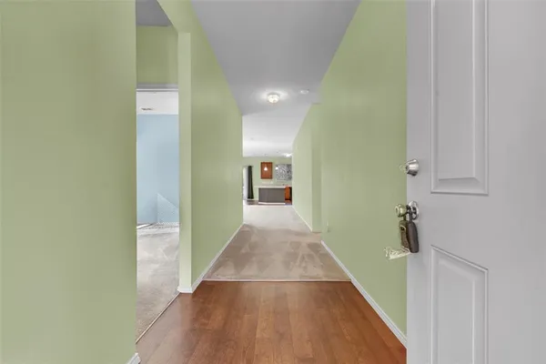 a view of a hallway with wooden floor