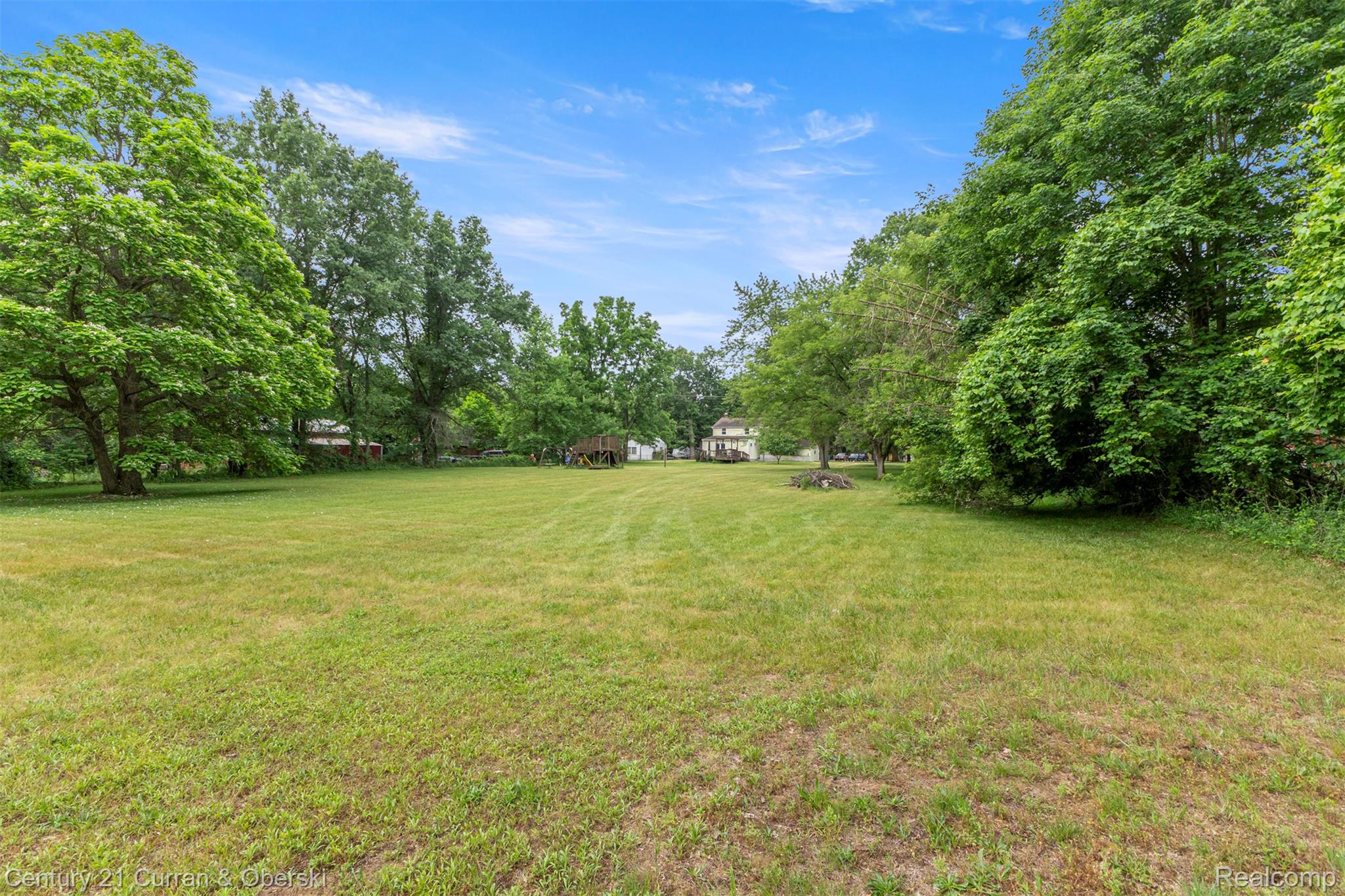 18491 Savage Road Belleville, MI 48111 - Photo 44 of 49 Expansive green space featuring a large grassy lawn and mature trees