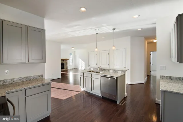 a kitchen with stainless steel appliances granite countertop a stove refrigerator and cabinets