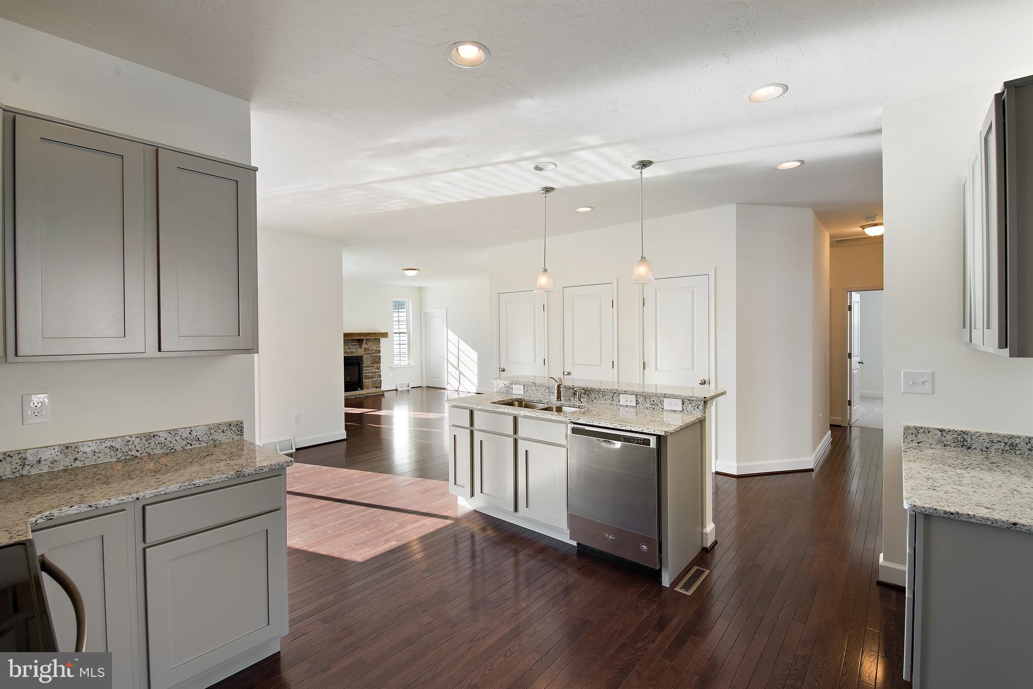185 East Audubon Drive, Unit 177 Gettysburg, PA 17325 - Photo 15 of 36 a kitchen with stainless steel appliances granite countertop a stove refrigerator and cabinets