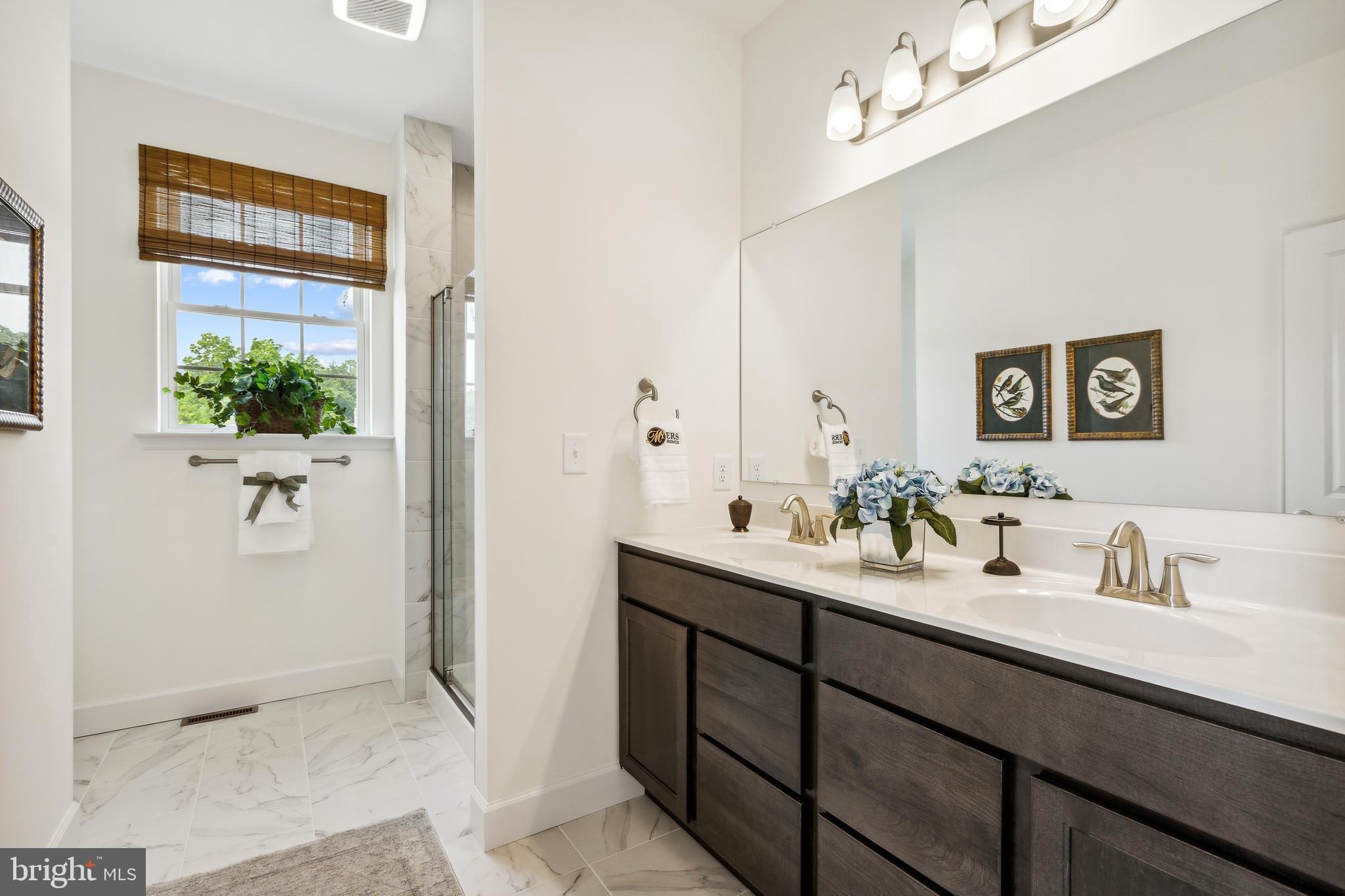 185 East Audubon Drive, Unit 177 Gettysburg, PA 17325 - Photo 19 of 36 a en suite bathroom with a double vanity sink and a mirror