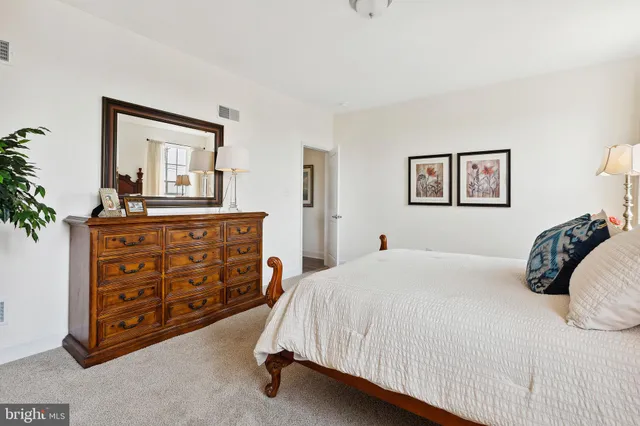 a bedroom with a bed and a dresser