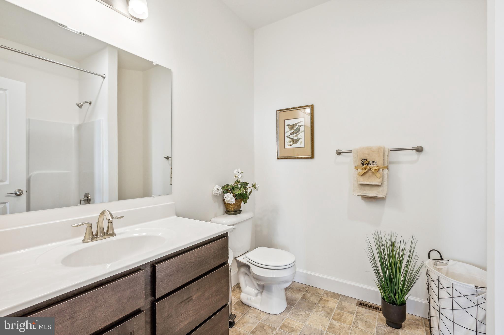 185 East Audubon Drive, Unit 177 Gettysburg, PA 17325 - Photo 33 of 36 a bathroom with a toilet sink and mirror