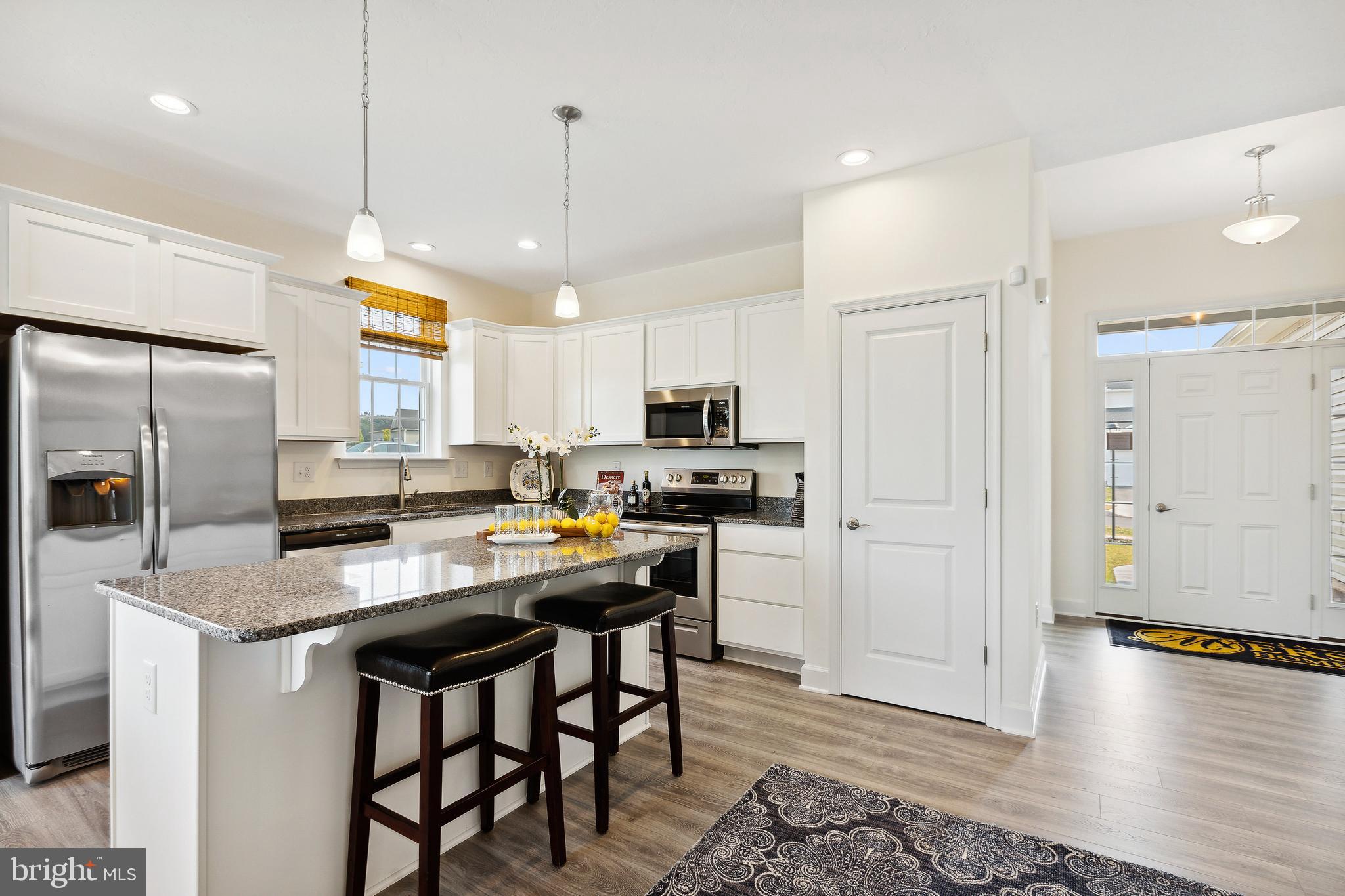 185 East Audubon Drive, Unit 177 Gettysburg, PA 17325 - Photo 10 of 36 a kitchen with stainless steel appliances granite countertop a refrigerator a sink dishwasher a stove and white cabinets with wooden floor