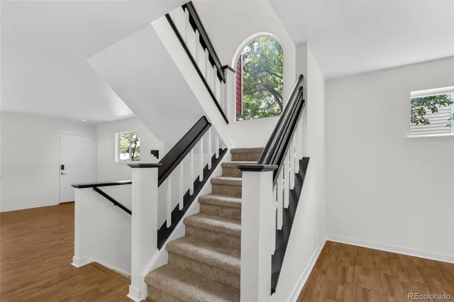 a view of entryway with wooden floor and stairs