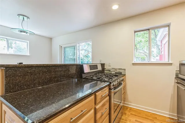 a view of kitchen sink stove and microwave