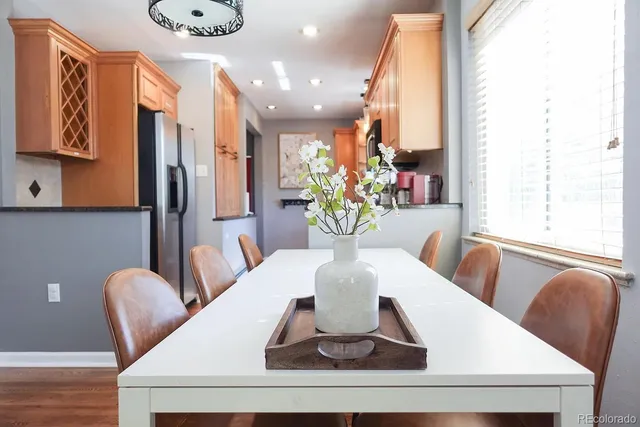 a view of a dining room with furniture and a potted plant