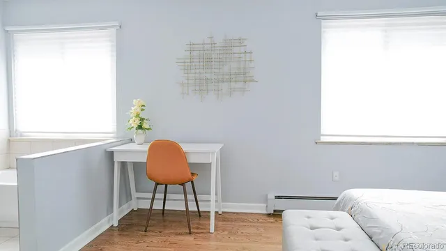 a bedroom with a bed a couch and a window