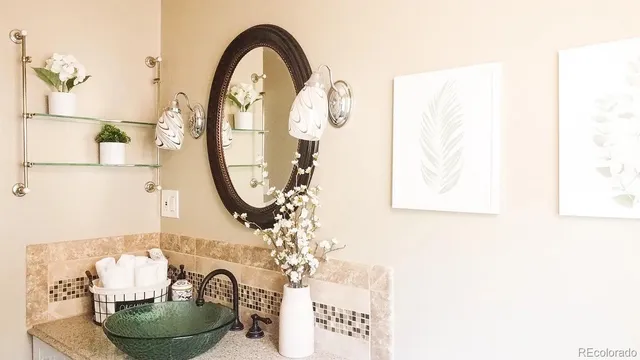 a room with a vase and a mirror