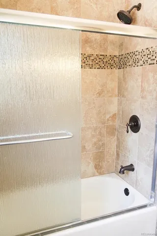 a bathroom with a shower and a sink