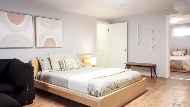 a bedroom with a bed and a painting on the wall