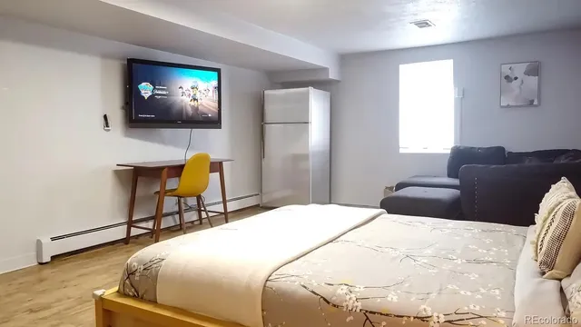 a bedroom with a bed and a couch