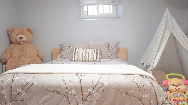 a bedroom with a bed and window