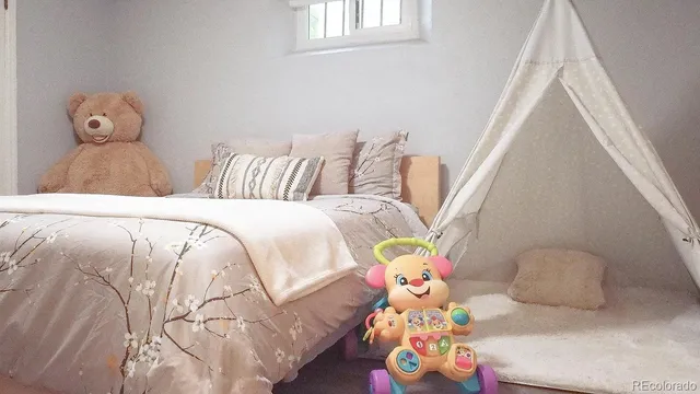 a bedroom with bed and two windows