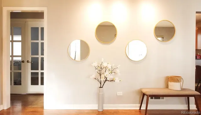 a front view of a house with wooden floor and a potted plant