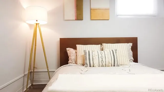 a bedroom with a bed and a night stand