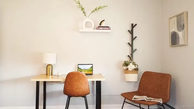 a view of a workspace with furniture and a couch