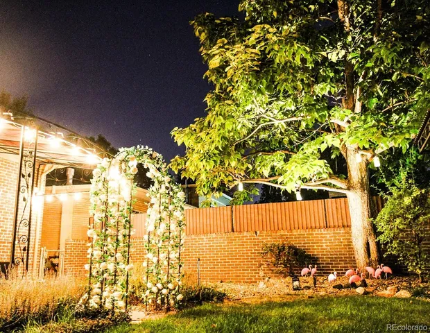 a view of a patio with table and chairs under an umbrella
