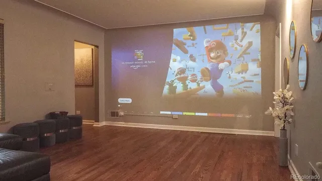 a view of a livingroom with wooden floor and a potted plant