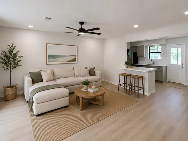 a living room with furniture and a wooden floor