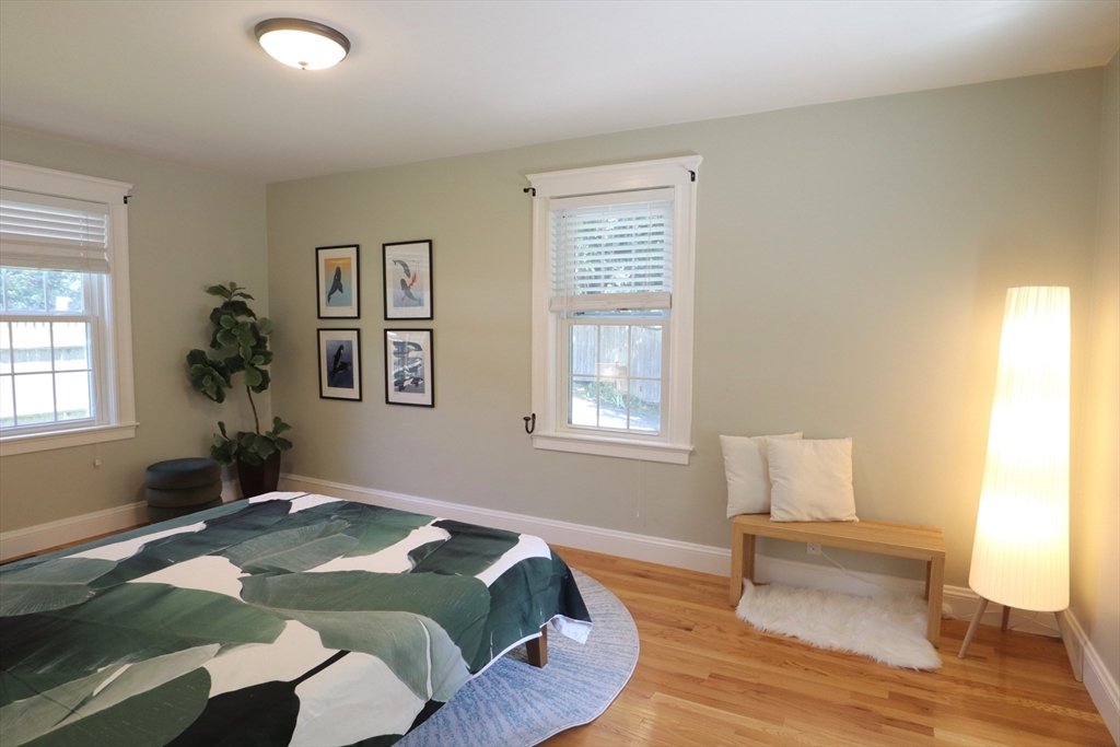 838 Worcester Street Wellesley, MA 02482 - Photo 13 of 42 a bedroom with a bed and a window