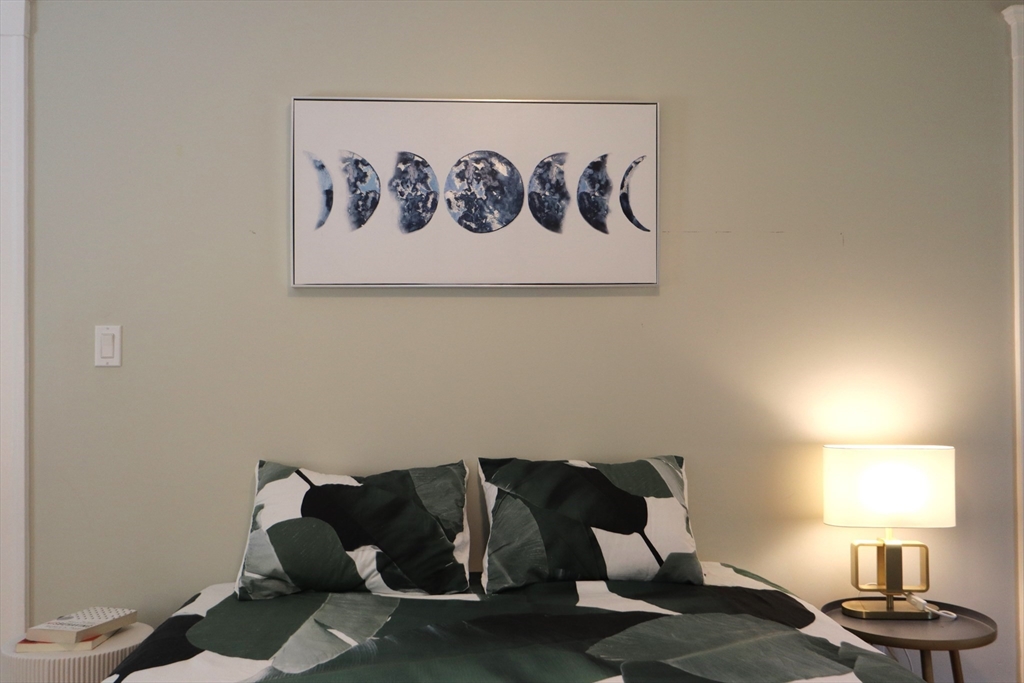 838 Worcester Street Wellesley, MA 02482 - Photo 15 of 42 a living room with a couch and a window