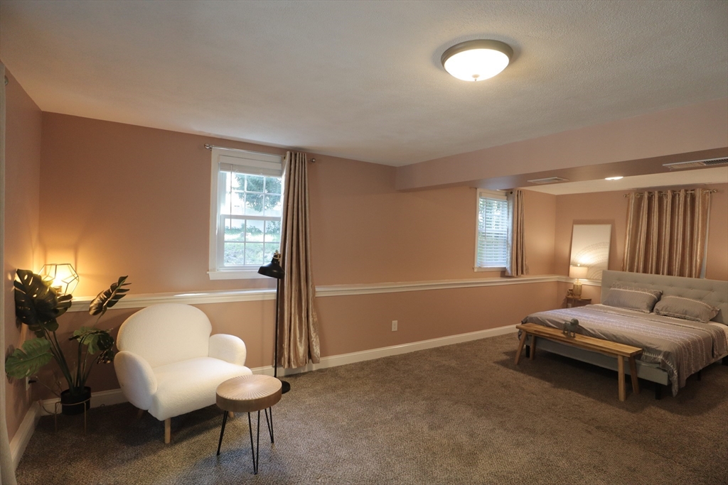 838 Worcester Street Wellesley, MA 02482 - Photo 17 of 42 a living room with furniture and a window