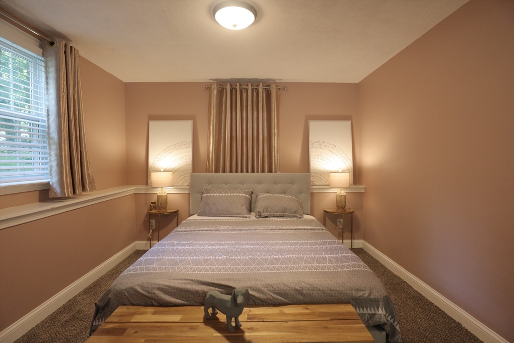 838 Worcester Street Wellesley, MA 02482 - Photo 18 of 42 a bedroom with a bed and a window
