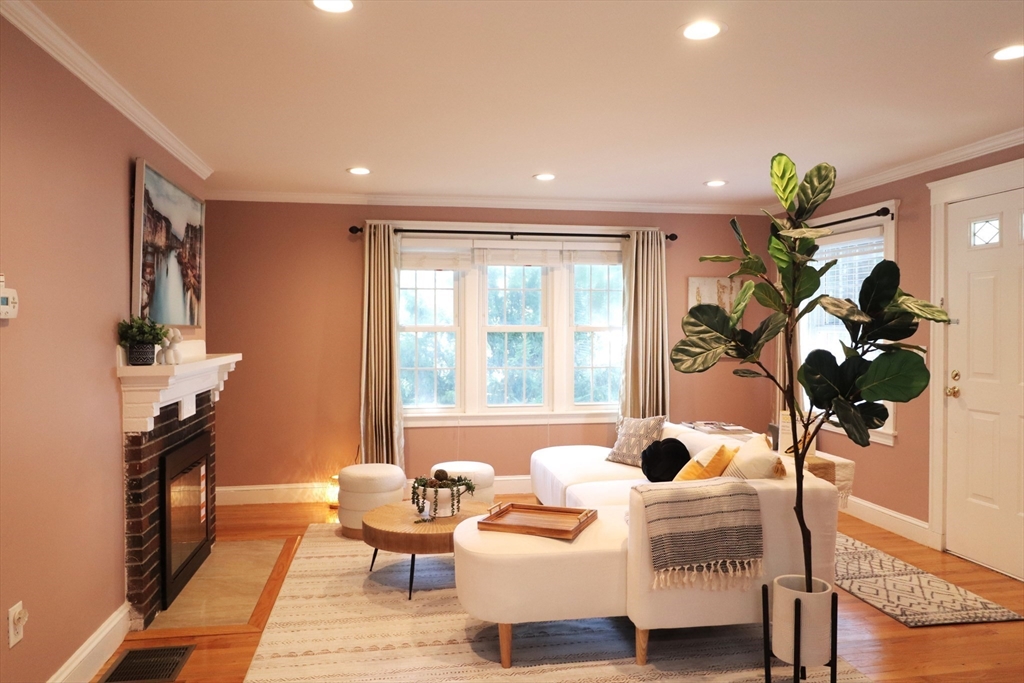 838 Worcester Street Wellesley, MA 02482 - Photo 2 of 42 a living room with furniture a chandelier and a window