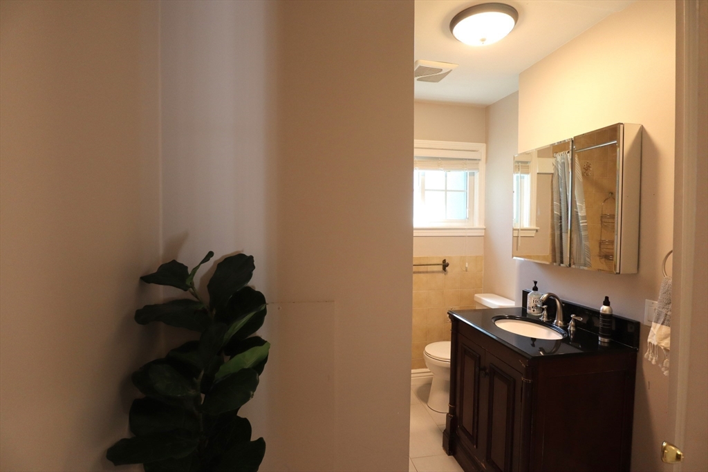 838 Worcester Street Wellesley, MA 02482 - Photo 28 of 42 a bathroom with a sink and a mirror