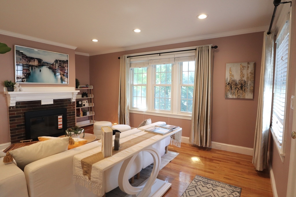 838 Worcester Street Wellesley, MA 02482 - Photo 3 of 42 a living room with furniture a fireplace and a large window