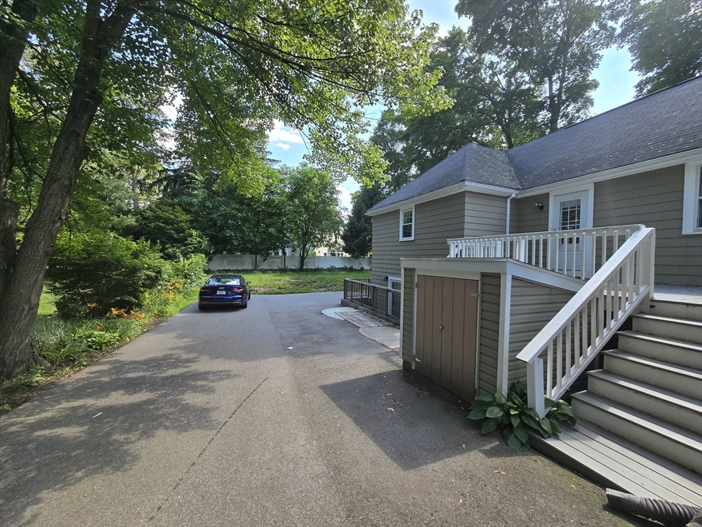 838 Worcester Street Wellesley, MA 02482 - Photo 38 of 42 a view of house with outdoor space and trees