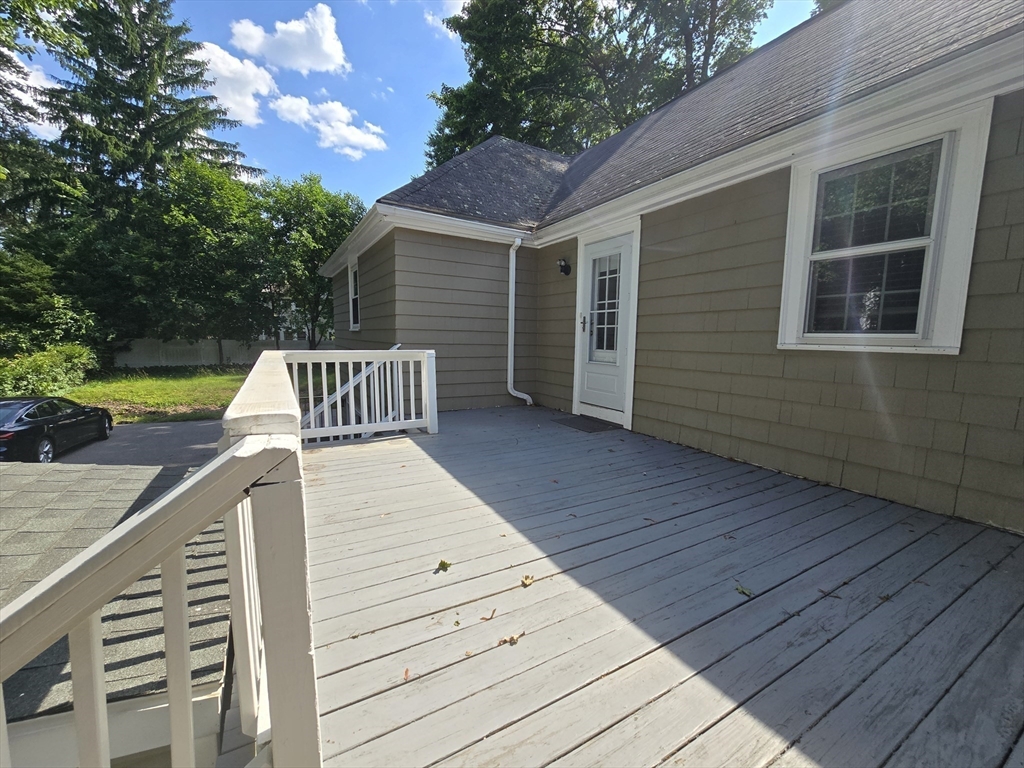 838 Worcester Street Wellesley, MA 02482 - Photo 39 of 42 a view of a roof deck with wooden floor and fence