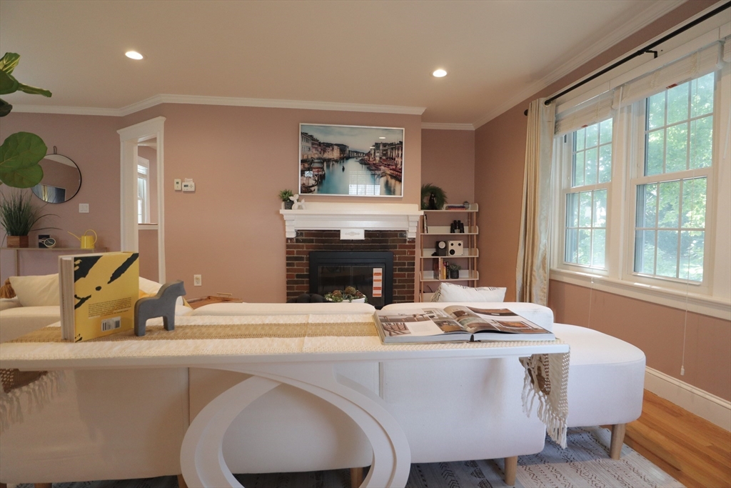 838 Worcester Street Wellesley, MA 02482 - Photo 4 of 42 a living room with fireplace furniture and a large window