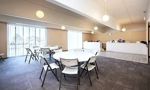 a view of a dining room with furniture and a large window